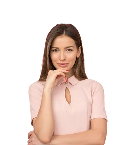 A woman with medium brown straight hair in a soft pink short-sleeved top with a delicate neckline cutout, posed thoughtfully with her hand near her face against a black background.