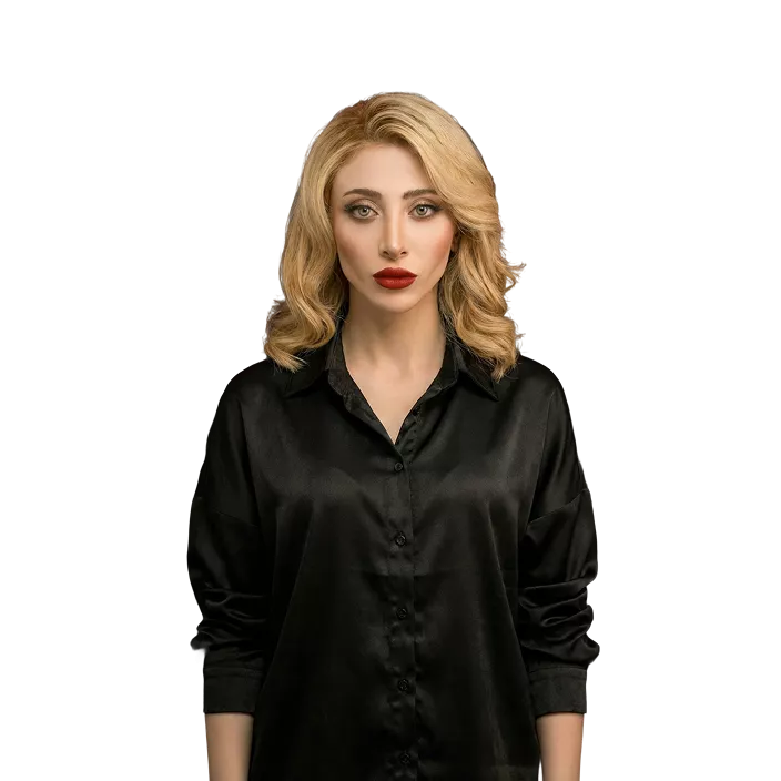 Woman with shoulder-length blonde wavy hair wearing black button-up shirt against black background