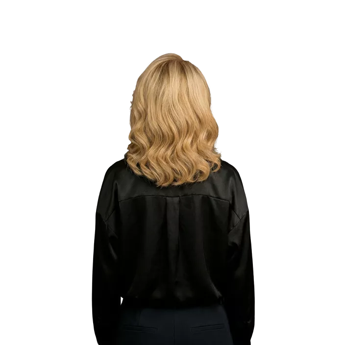 Woman with shoulder-length blonde wavy hair wearing black button-up shirt against black background