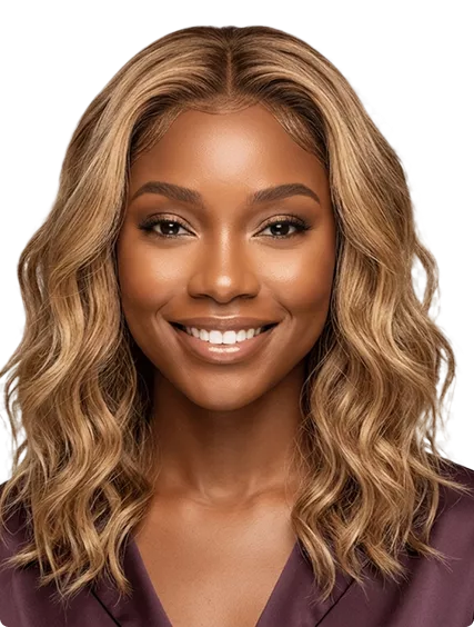 A smiling woman with highlighted blonde wavy hair wearing a satin top against a soft purple studio background.